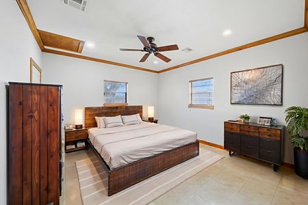 Beautifully staged secondary bedroom with a queen size bed, 2 dressers and a side table in the home of 2365 S. FM 46 in Franklin, TX