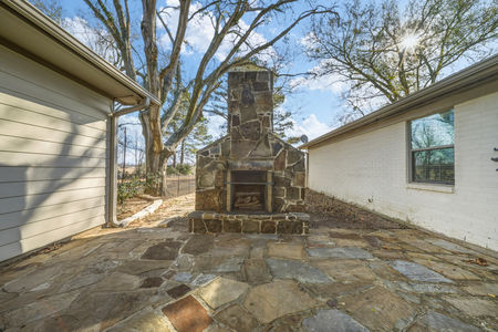 Beautiful stone patio and stone fireplace at 2365 S. FM 46 in Franklin, TX