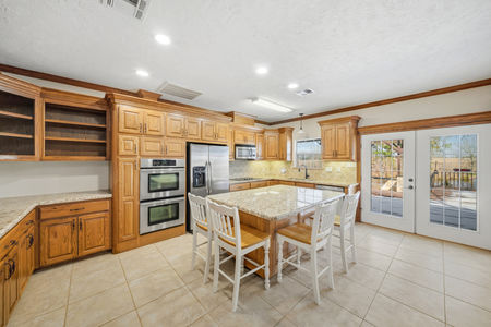 Secondary kitchen with large island and tons of built ins in 2365 S. FM 46 in Franklin, TX