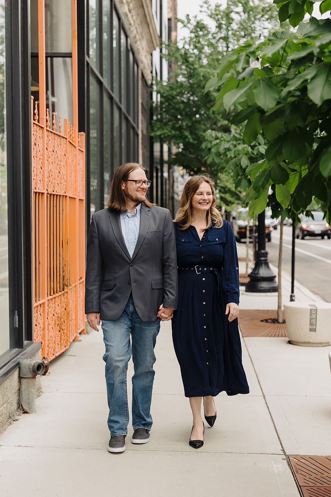 Couple-walking-downtown-holding-hands-casual-elegant-outfits