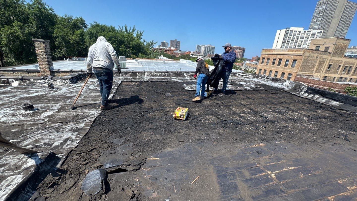 Roofing crew removing the existing flat roof