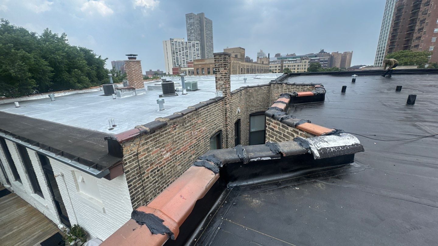 Flat roof installation in progress at the Chicago multifamily building