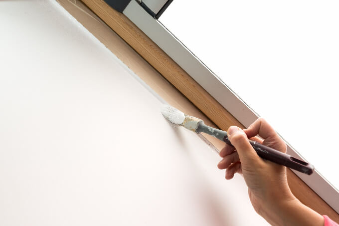 Brush painting the window recess of the sloping roof window - painting concept (small)