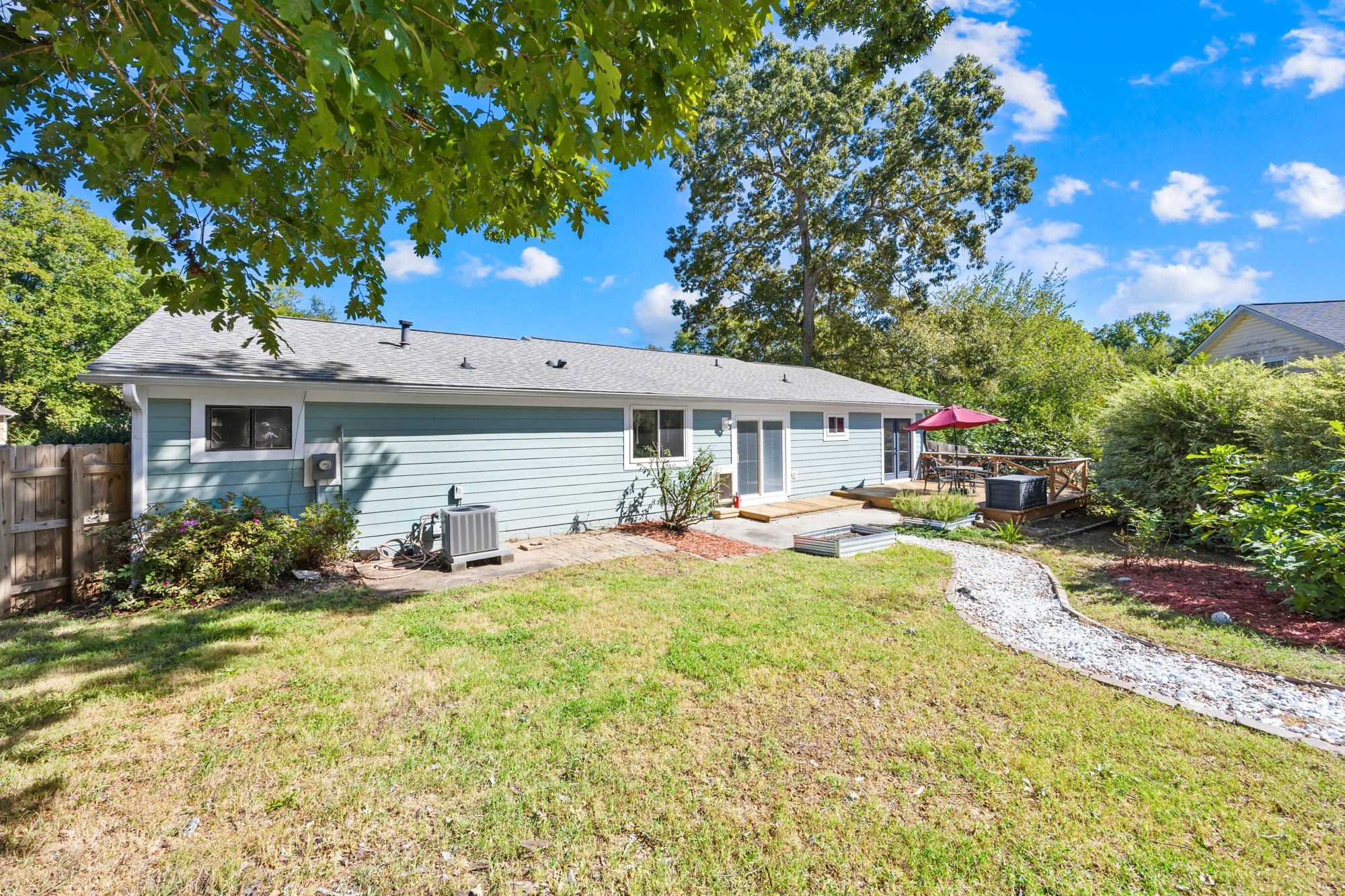 Fenced backyard with gravel path at 4900 Cricklewood Lane