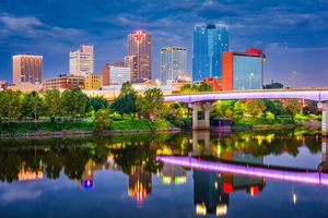 Downtown Little Rock, Arkansas skyline at night reflecting on the Arkansas River – a top real estate market in 2025 for home buyers and sellers.