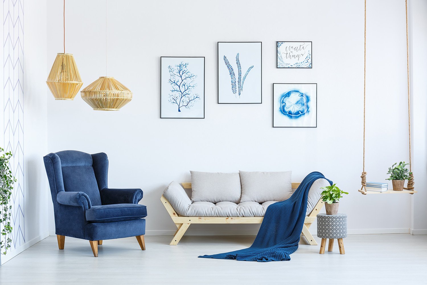 White,Sofa,And,Blue,Armchair,In,Living,Room,With,Posters