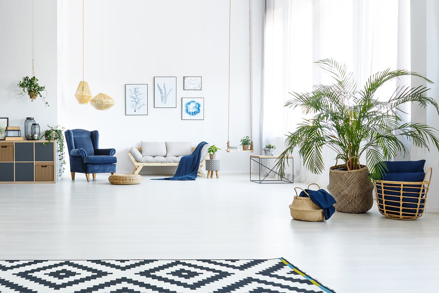 White,Living,Room,With,Couch,,Blue,Armchair,And,Decorative,Plant
