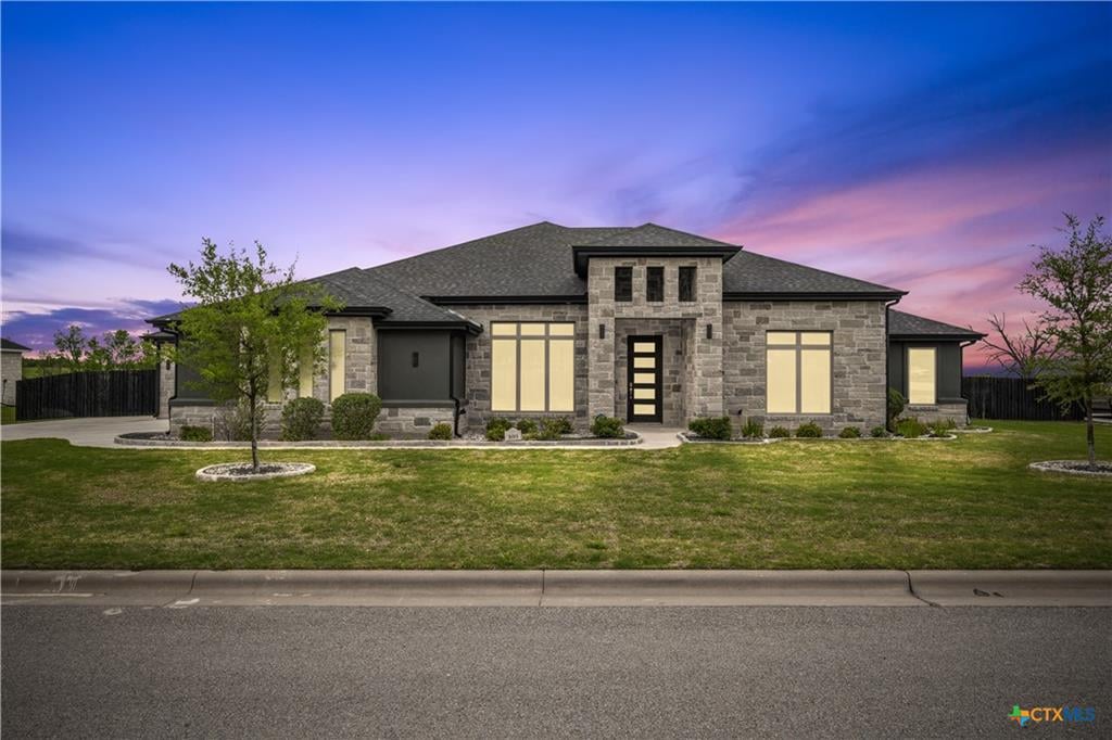 Modern stone luxury home at blue hour