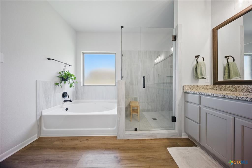 Omega Builders primary bathroom with solid surface vanity