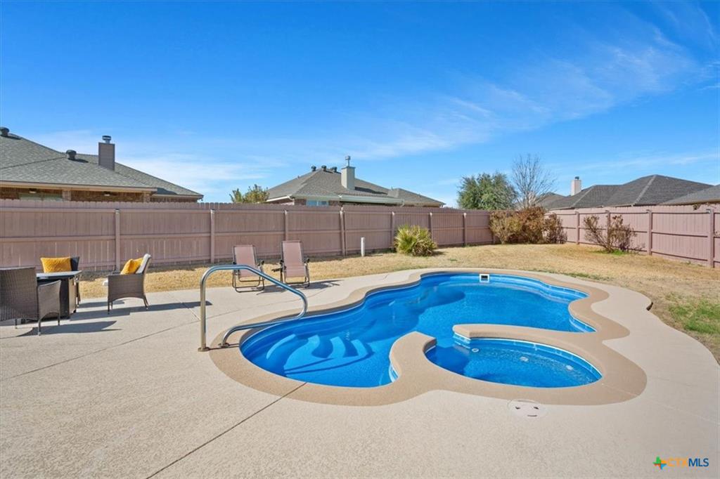 Backyard with pool at Carriage House Trails Temple TX