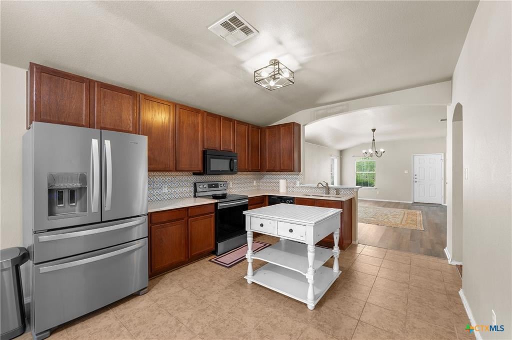 Updated kitchen with island and modern cabinetry in Windmill Farms home
