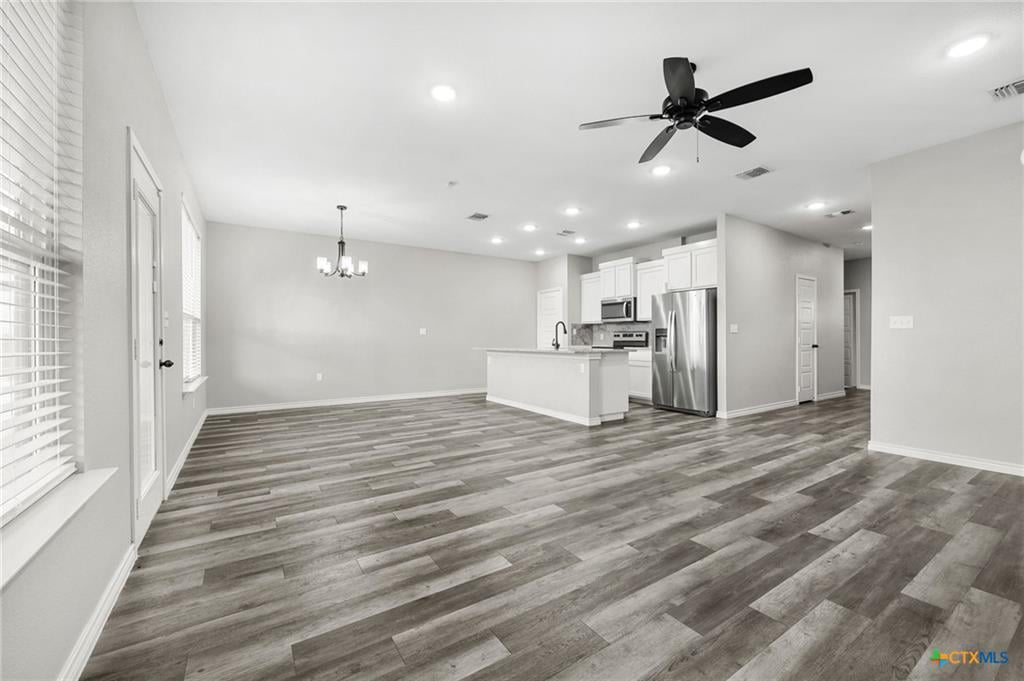 7713 Purvis Street open-concept living to kitchen — natural light, modern finishes, 1,536 sqft floor plan