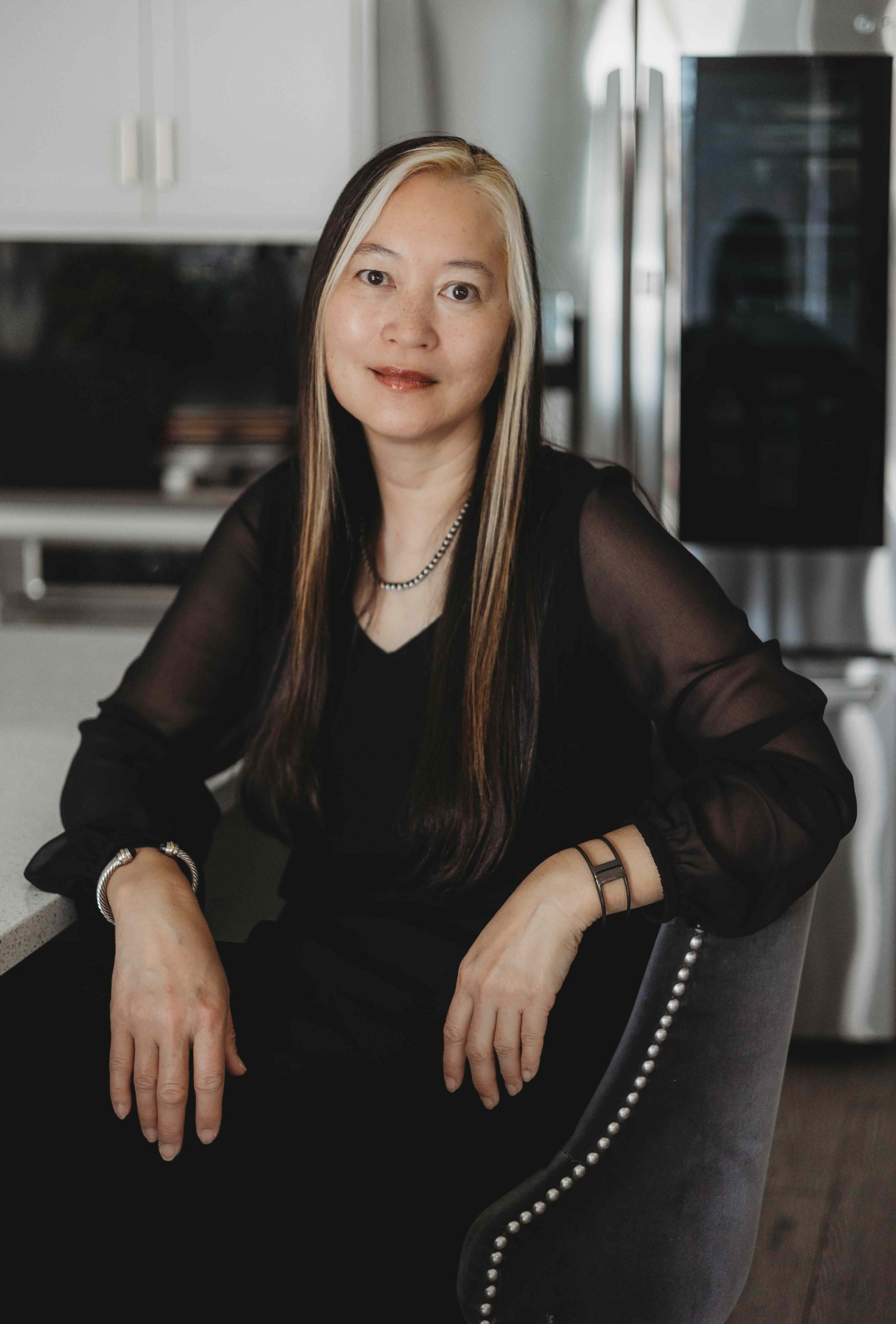 AA-black dress sitting in chair-sm