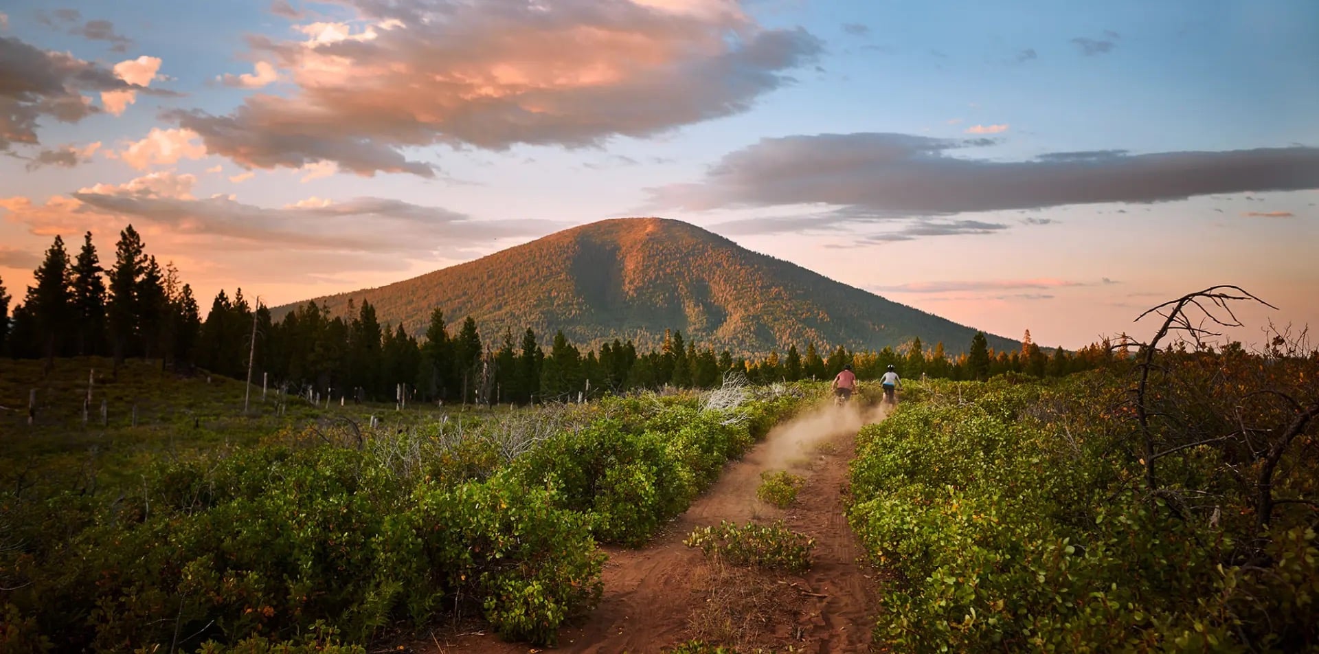 Black Butte mountain at sunset with mountain bikers on trail, Sisters Oregon