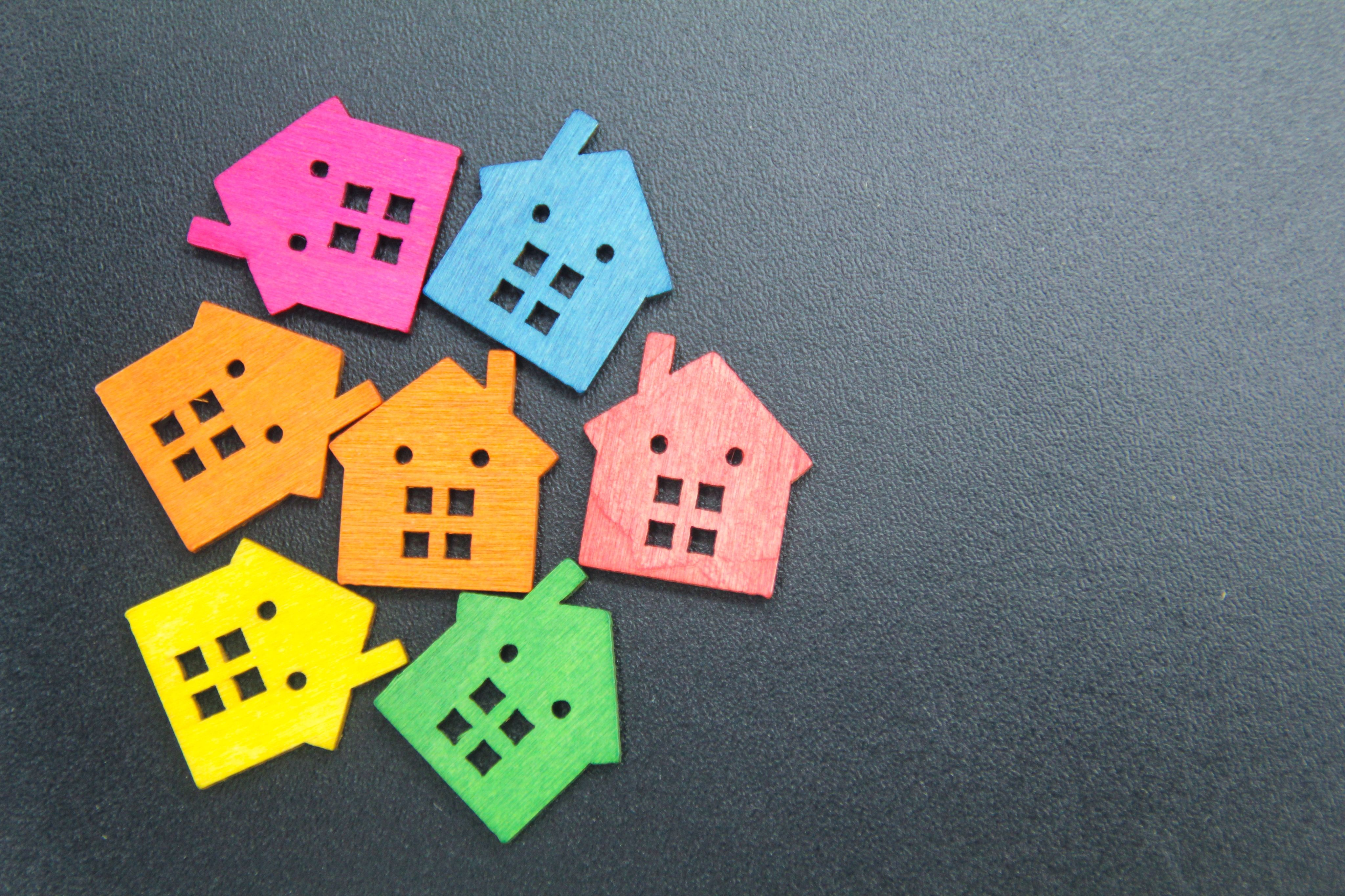 a small colored wooden house with a real estate or mortgage concept with a copy space on the side