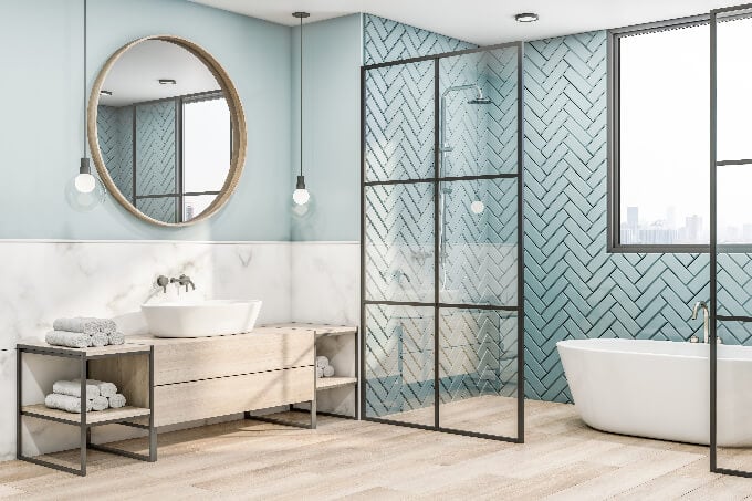 Side view on eco interior design of bathroom with wooden frame of round mirror on blue wall, (small)