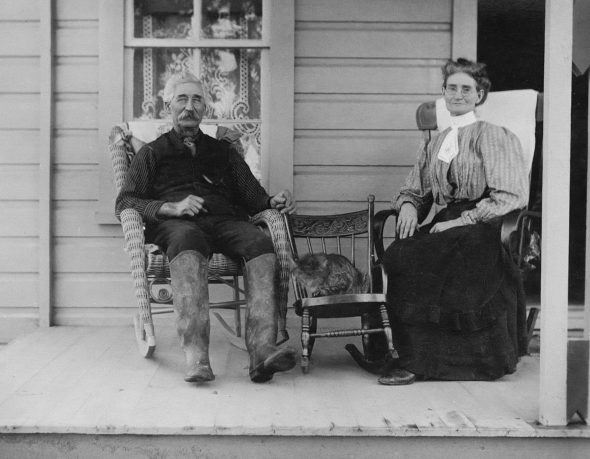 Senior couple sitting on their home porch in Pittsburgh enjoying property tax relief