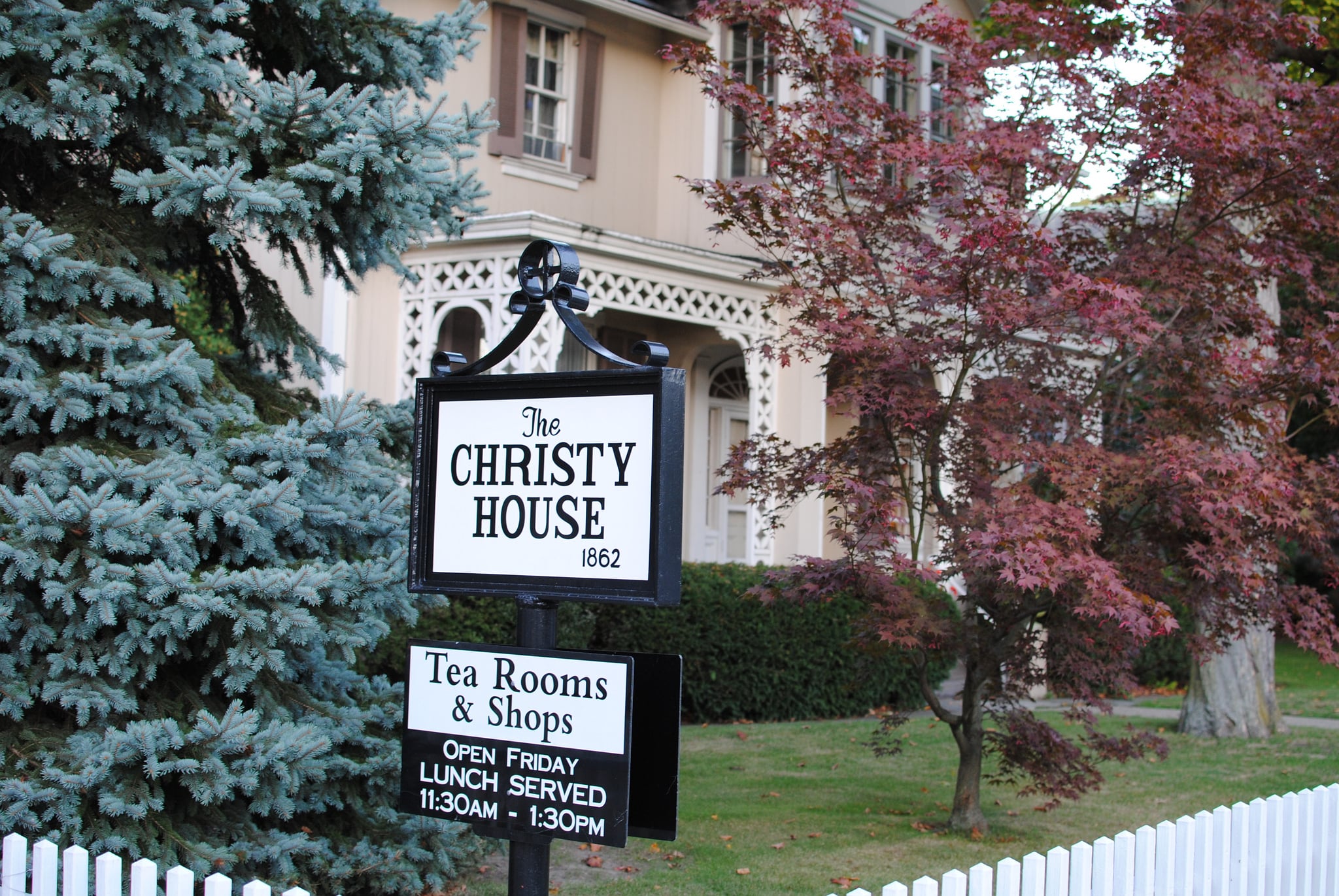The Christy House in Sewickley borough, a historic residence with a white picket fence and mature trees