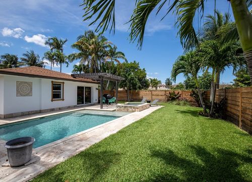 Backyard of a modern house with swimming pool and artificial grass