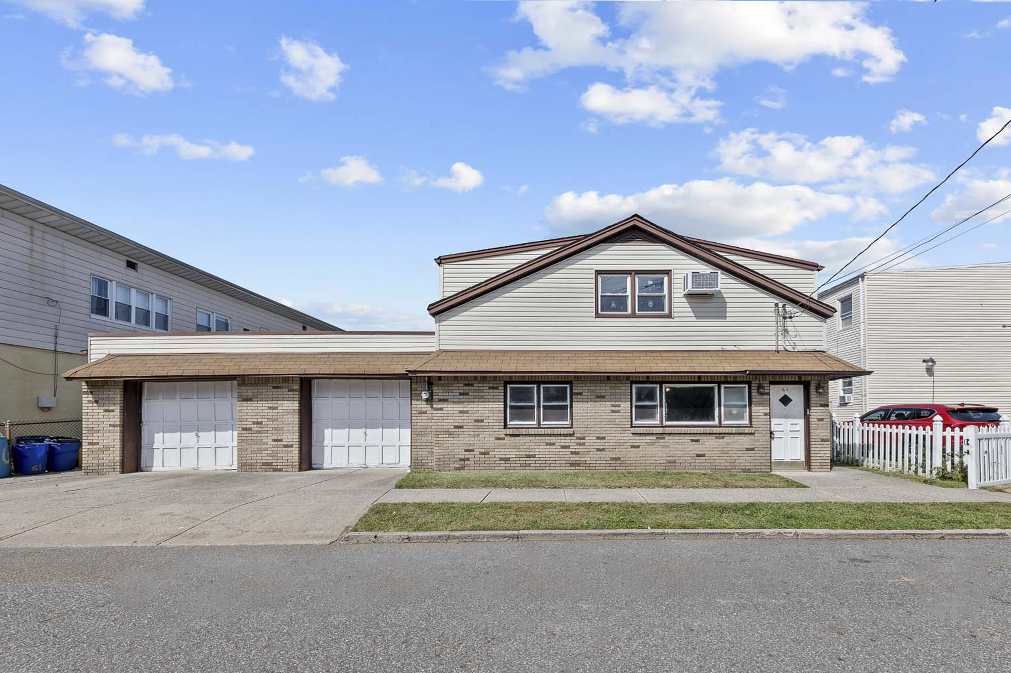 Street view of a 2 family house with an attached 2 car garage in Garfield NJ