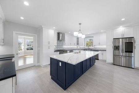 Kitchen with blue island cabinetry