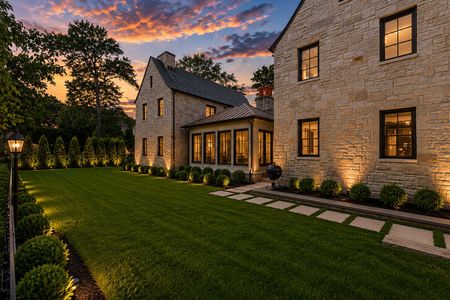 15. 548 Sylvan Pl Haworth Elegant twilight backyard with glowing stone house