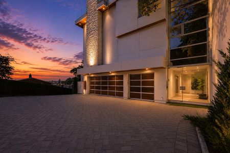 3-31 Casta Modern house at sunset with driveway