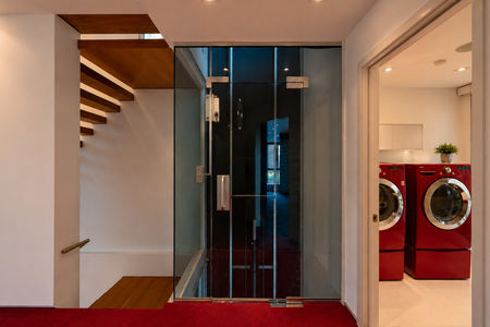 37-31 Casta Modern hallway with glass elevator and laundry room