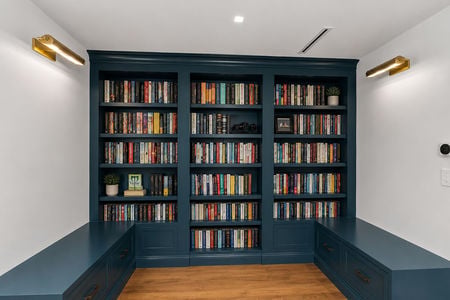 45 548 SYlvan Pl Modern study nook with teal bookshelves