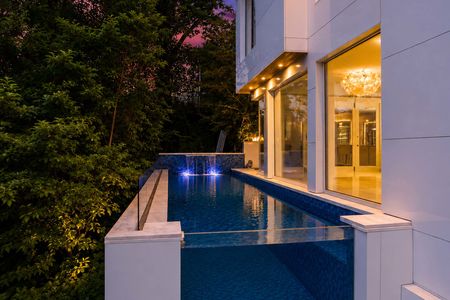 48-31 Casta Modern home with infinity pool at dusk