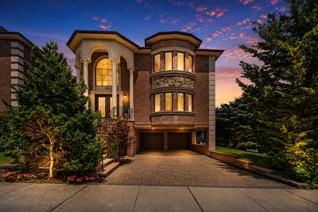 11. 335 Riverdale Elegant home at twilight with warm glow