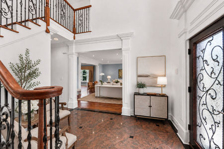 15. 335 Riverdale Elegant foyer with staircase and artwork