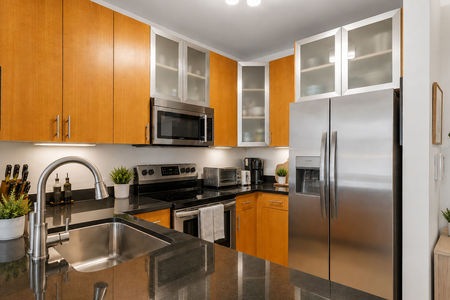 21. 26 Ave Port Imperial Modern kitchen with sleek finishes