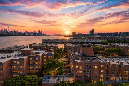 26. 303B Nelson Sunset over waterfront cityscape
