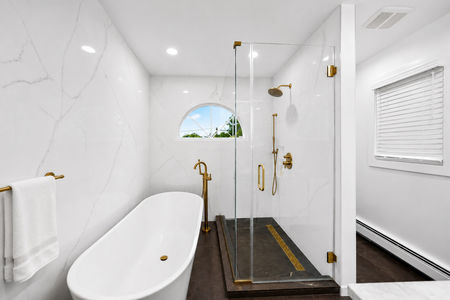 26. 5 Gates Pl. Luxurious marble bathroom with gold accents