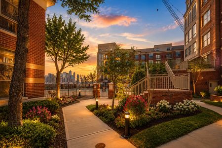 3. 26 Ave Port Imperial Serene courtyard at sunset with skyline