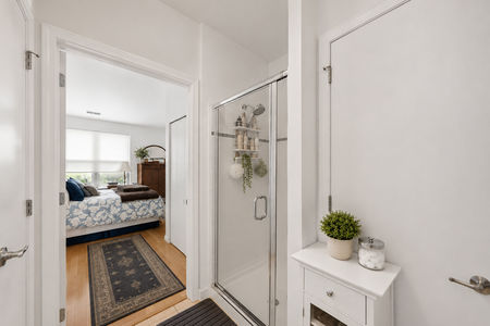 35. 26 Ave Port Imperial Modern bathroom leading to cozy bedroom