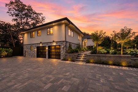 6. 35 Jane Modern home at sunset with lush landscaping