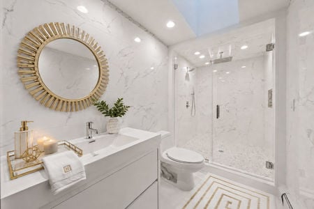 0.35. 1 Lambs Luxurious White Marble Bathroom with Gold Accent