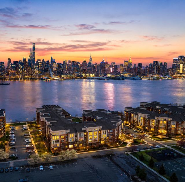 26 Ave Port Imperial Twilight cityscape over calm water