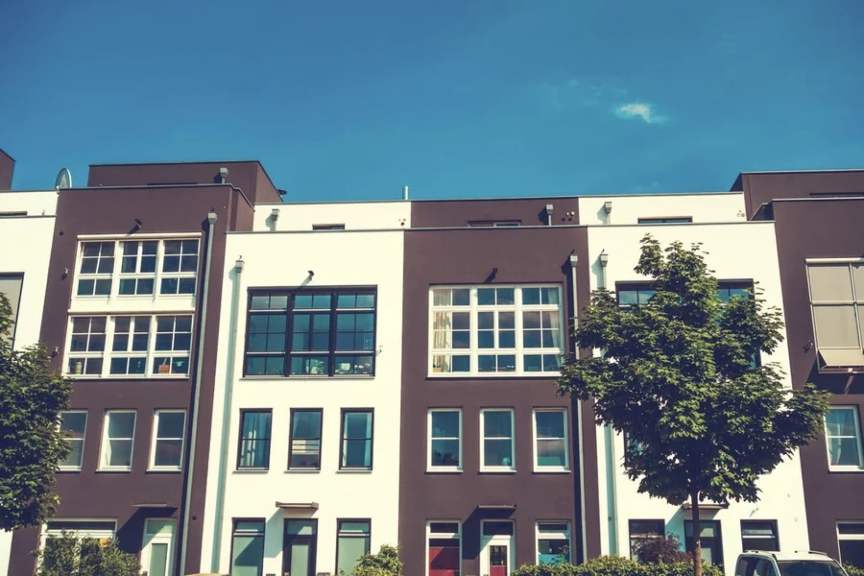 Tall, modern brown and white townhouses
