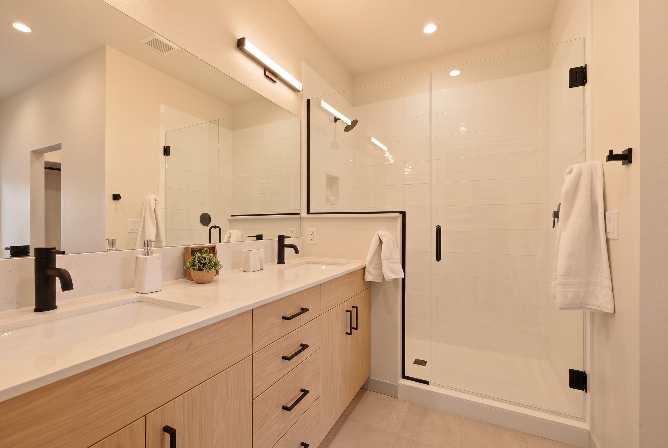 Owner's bath with double vanity and glass shower