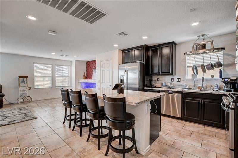 Kitchen with granite island and bar seating at 105 Campbelltown Avenue, Cadence Henderson