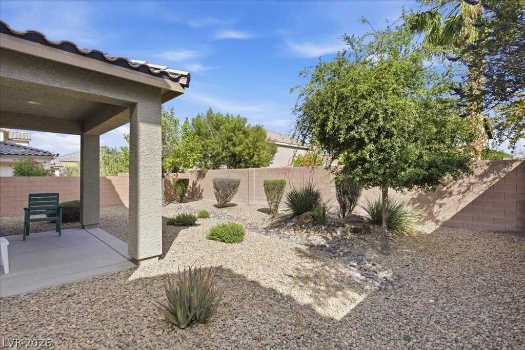 Covered patio and desert-landscaped backyard at 3413 Pelican Brief Lane
