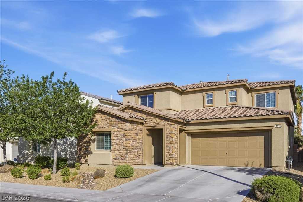 Front exterior of 3413 Pelican Brief Lane, a two-story home with a tile roof and two-car garage in North Las Vegas