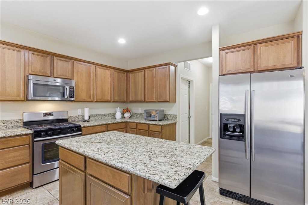 Kitchen with center island and stainless steel appliances at 3413 Pelican Brief Lane