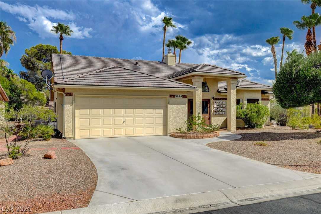 5020 Pacific Grove Drive single-story home exterior with two-car garage and desert landscaping