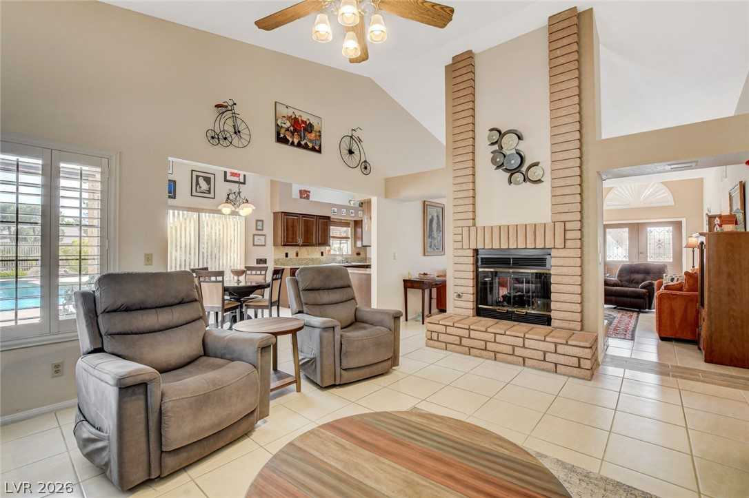 Family room with vaulted ceiling and two-way fireplace at 5020 Pacific Grove Drive