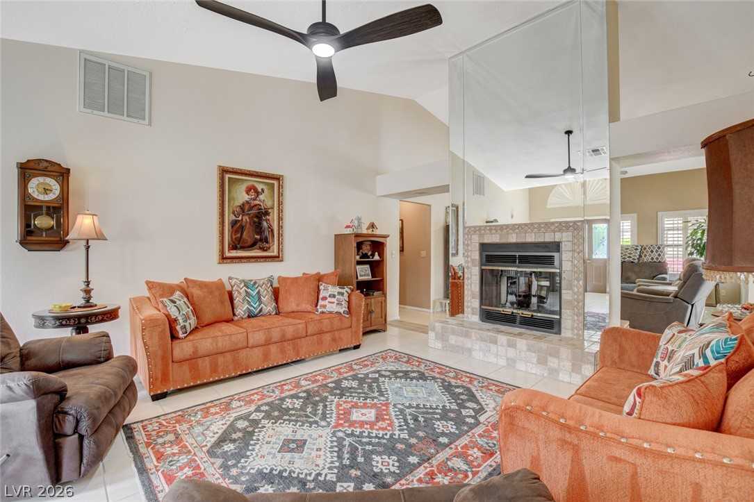 Living room with multi-sided gas fireplace at 5020 Pacific Grove Drive