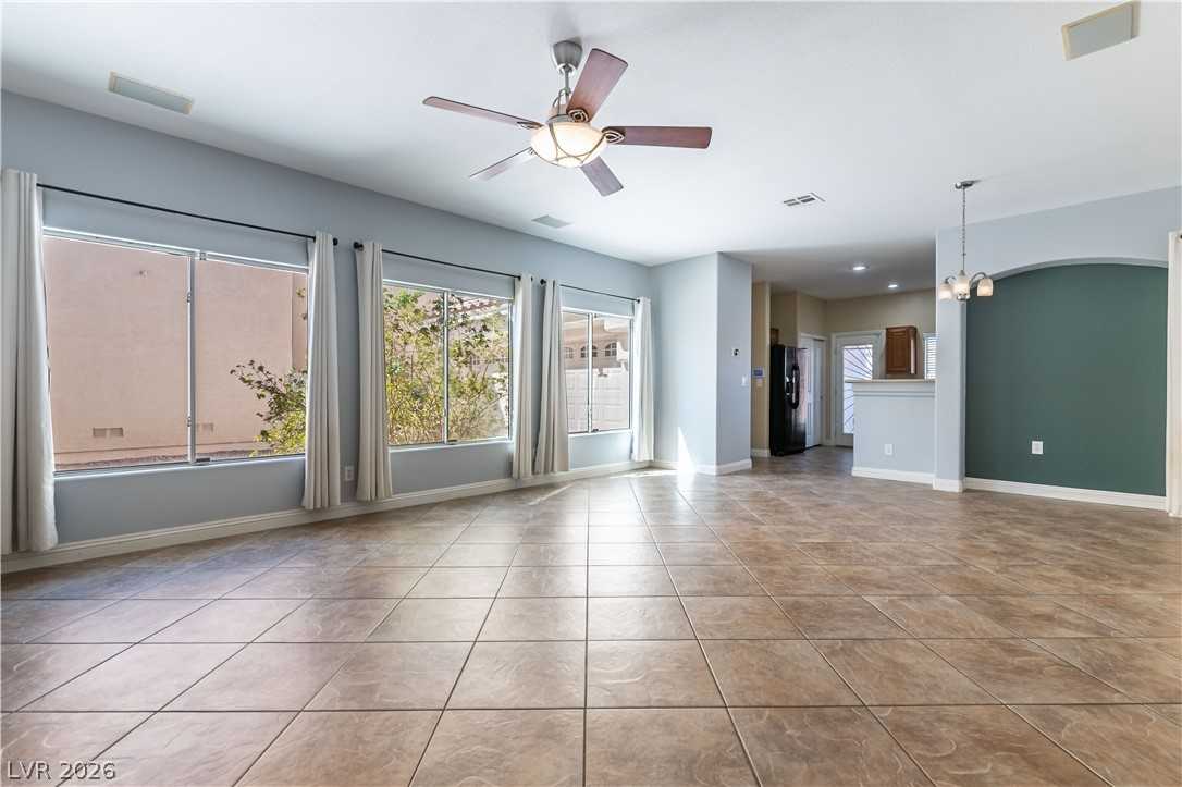 Great room with tile flooring and large windows at 9010 Mossy Hollow Avenue